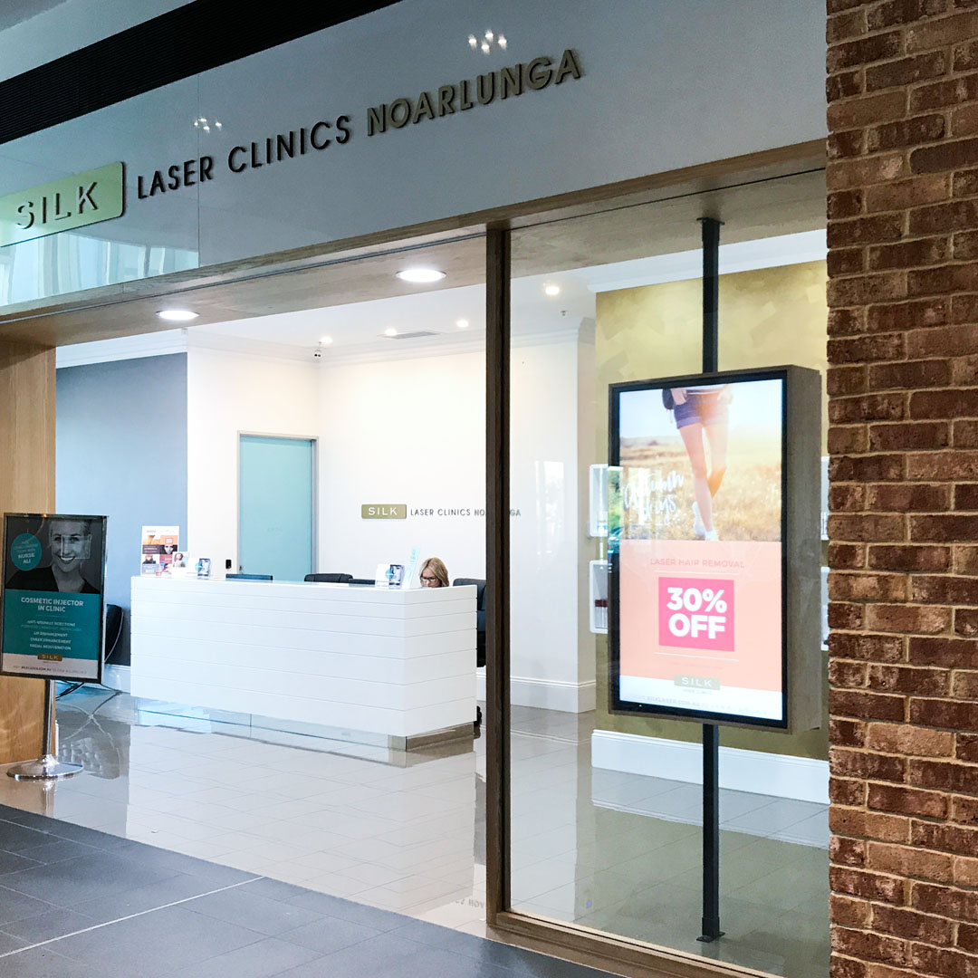 LCD digital sign in Silk Laser Clinic window display